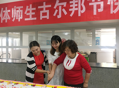 爱心社工作人员和新疆内派老师为孩子们切蛋糕.jpg